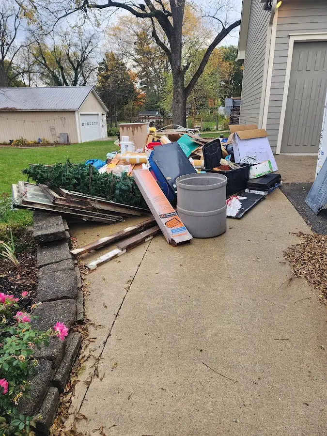 Dumpster being loaded with debris for 12 Yard Dumpster Rental in Archer Lodge